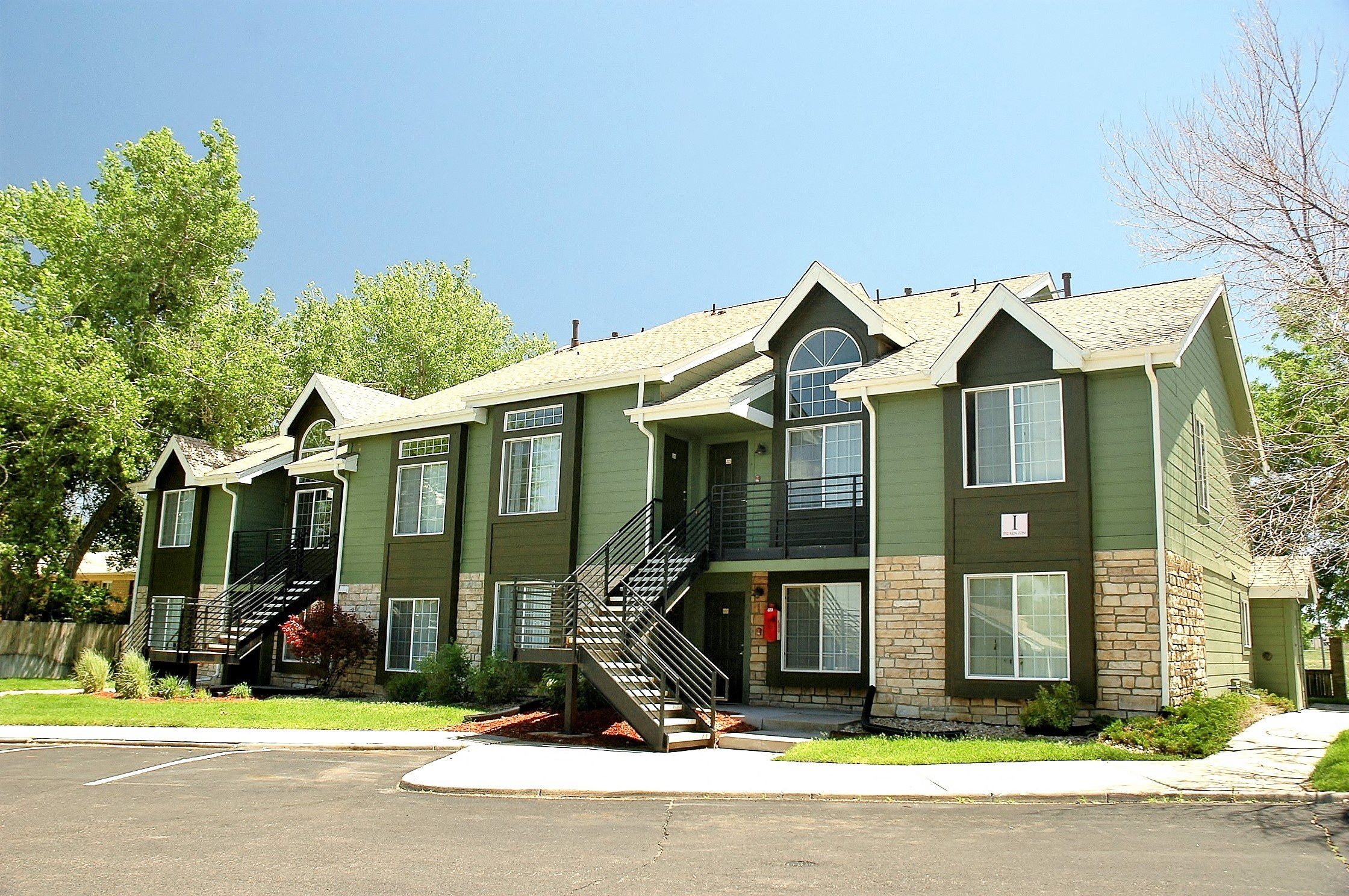 Residences at First Ave apartment building, painted green, exterior entrances